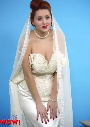 Natural redhead Lucy V slips off her wedding dress to bare big natural tits