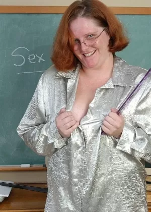 Fat redheaded teacher Adrienne exposing mature pussy for masturbation in class