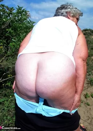 Толстая бабуля в очках демонстрирует свои дряблые сиськи и киску