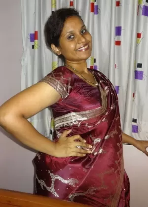 Clothed Indian woman strips to her black bra and underskirt