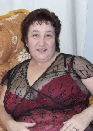 Mature BBW Kinky Carol models sexy lingerie in mesh stockings and heels