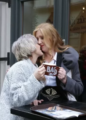 Mature lesbians flash upskirts on stairs while walking out in public