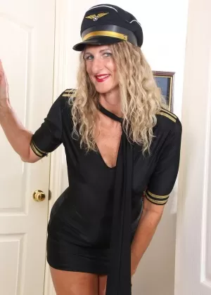 Mature blonde Layla Wolf strips off her pilots uniform for nude poses