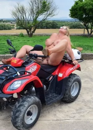 Older BBW Nude Chrissy goes four wheeling while butt naked in shades