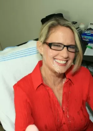 Fully clothed mature blonde in glasses gives a handjob and gets bukkaked