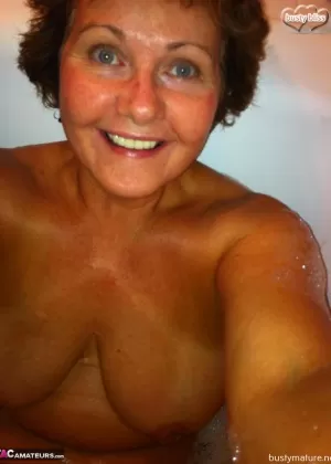 Older amateur Busty Bliss completely disrobes before taking a shower