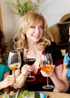 Mature lady Nina Hartley encourages a couple of couples to drink up