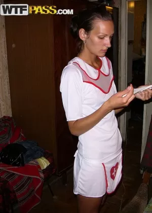 Amateur chick Dasi West poses non nude in a naughty nurse outfit on a bed