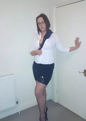 Великолепная зрелая красотка с аппетитной попкой позирует в униформе горничной