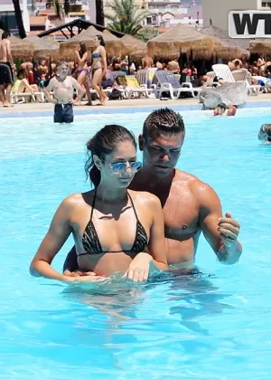 Amateur chick Nessa models a bikini in a pool before going naked on a balcony