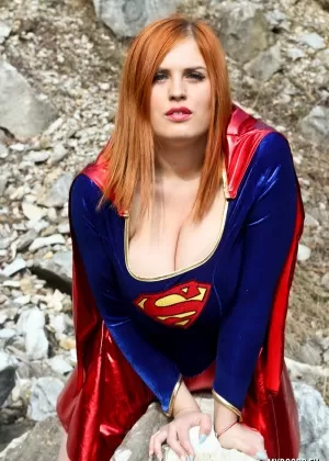 Thick redhead Alexsis Faye releases her giant tits from Superman osutfit