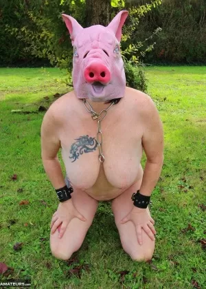 Busty amateur Mary Bitch sports a pigs head clamps and a strapon on a lawn